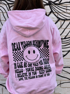 BE KIND (front): DEAR PERSON BEHIND ME (back), pink hoodie with black graphic