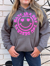 Load image into Gallery viewer, HAVE THE DAY YOU DESERVE SMILEY FACE: charcoal gray hoodie with hot pink graphic
